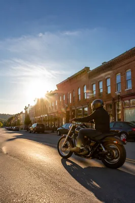 Lone Motorcycle Rider on Sunlit Main Street