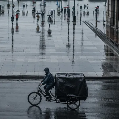 Rainy City Street Reflections with Umbrella