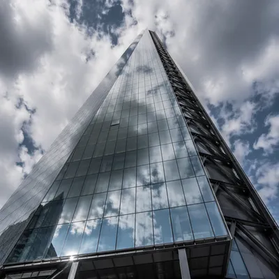 Modern Glass Skyscraper Reaching Cloudy Sky