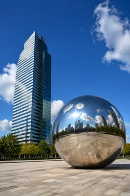 Modern Skyscraper Reflection in Sunny Plaza