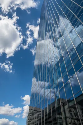 Modern Glass Skyscraper Reflecting Blue Clouds