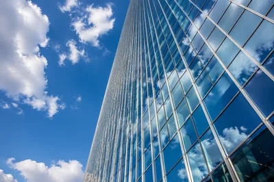 Modern Glass Skyscraper Reflecting Blue Clouds