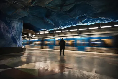 Solitary Commuter on Cave-Like Metro Platform