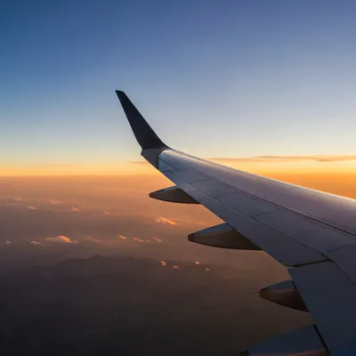 Sunset Airplane Window View Above Golden Clouds