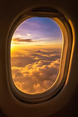 Golden Sunset Clouds Through Airplane Window