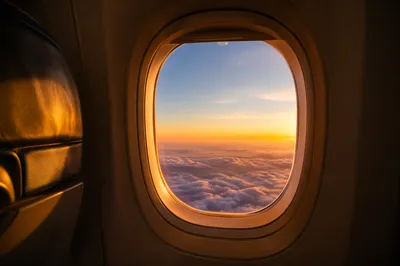 Golden Sunset Through Airplane Window