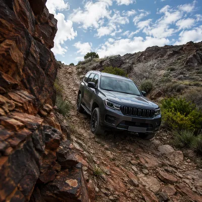 Rugged SUV Descending Rocky Mountain Trail