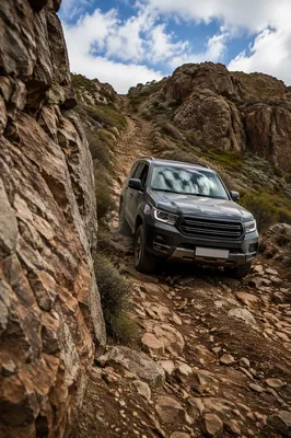 Rugged SUV Descending Rocky Mountain Trail