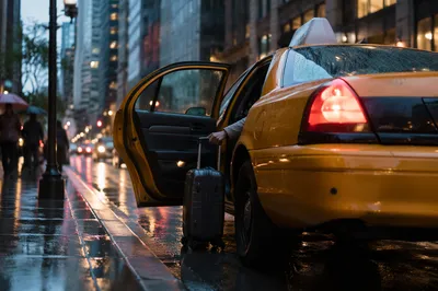 Yellow Taxi Arrival on Rainy Downtown Street