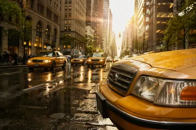 Rainy City Street with Yellow Taxi
