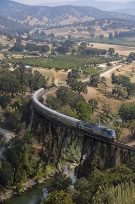 Passenger Train Crossing Rural River Bridge