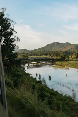 Passenger Train Crossing Rural River Bridge