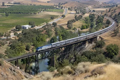 Passenger Train Crossing Rural River Bridge
