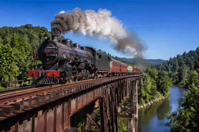 Vintage Steam Train Crossing River Bridge