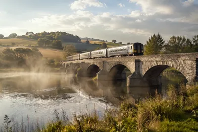 Regional Train Crossing Stone Bridge at Dawn