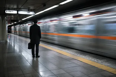Evening Commuter Waiting on Urban Train Platform