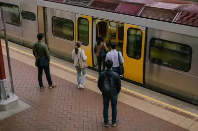 City Commuters Boarding Modern Train