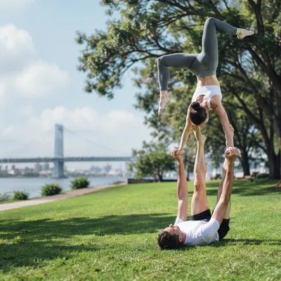 Couple Practicing Partner Yoga in Urban Park
