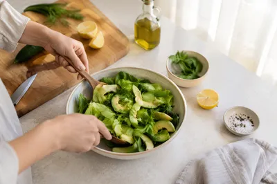 Fresh Green Salad Preparation in Sunlit Kitchen