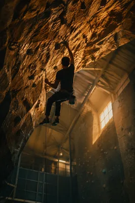 Indoor Climber on Overhanging Gym Wall