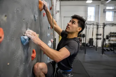 Man Climbing Indoor Rock Wall