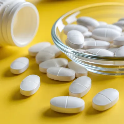 White Vitamins on Bright Yellow Tabletop