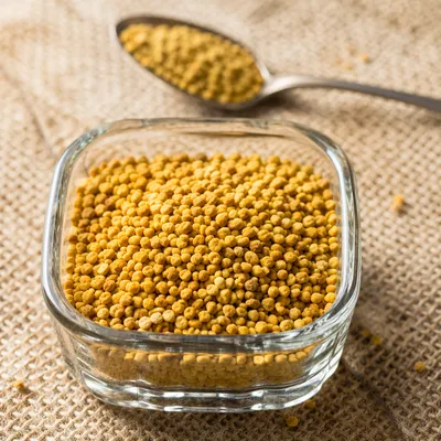 Golden Vitamin Granules in Glass Dish